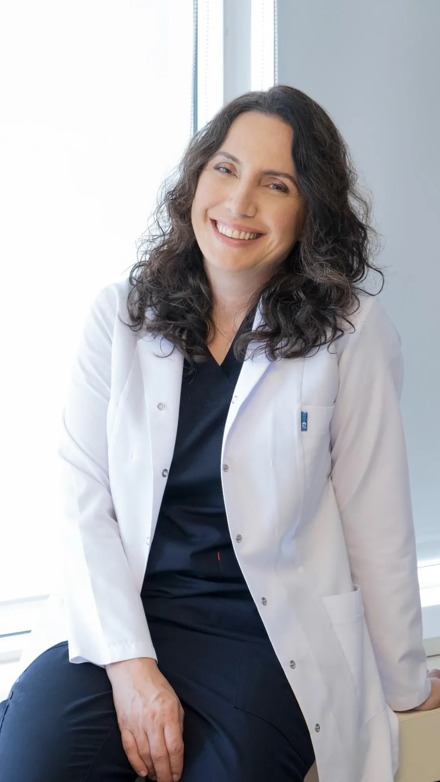 Prof. Dr. Ayşenur Meriç Hafız, beyaz önlüğüyle kliniğinde